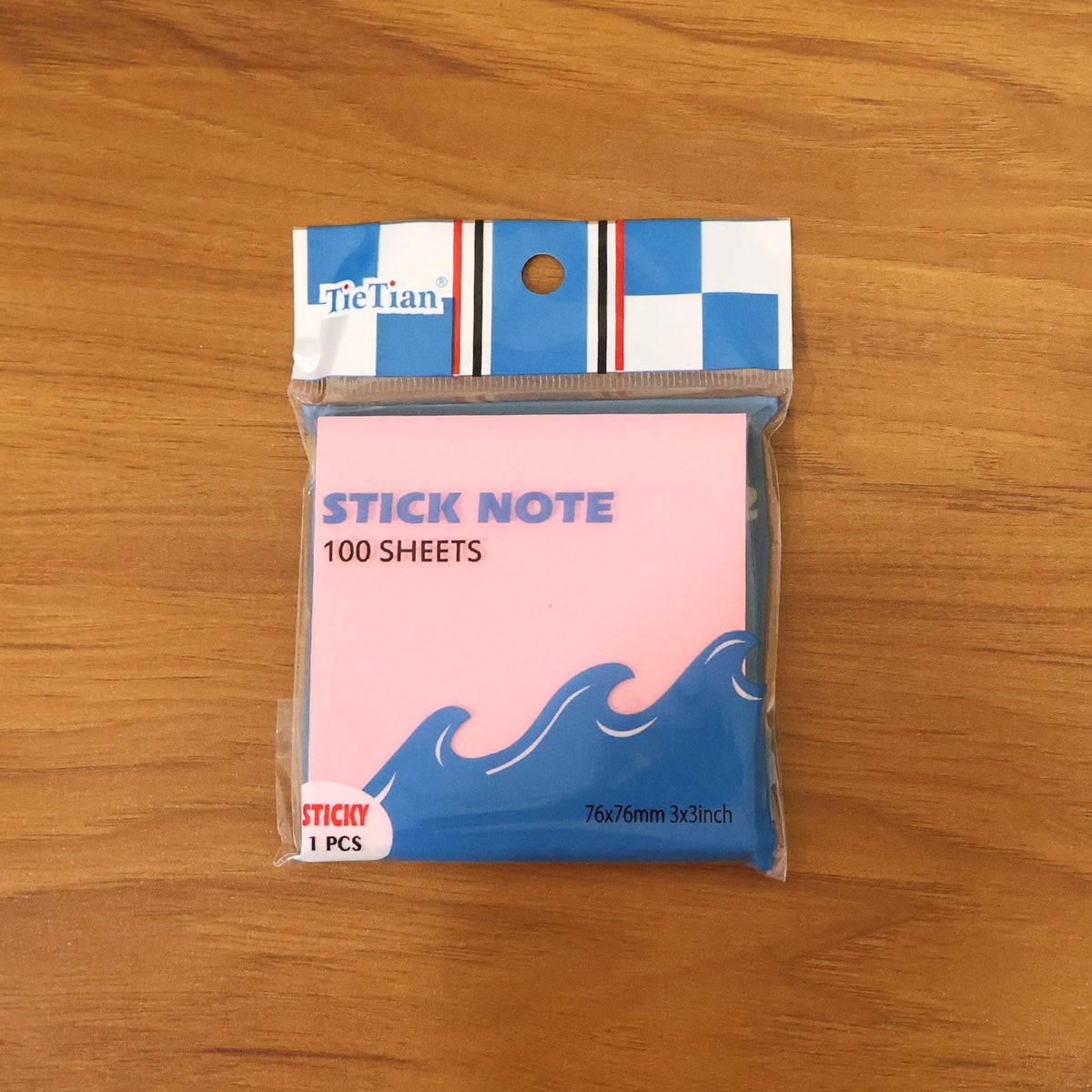 A single pack of pink sticky notes with blue wave design, labeled "STICK NOTE 100 SHEETS", in clear plastic packaging on a
