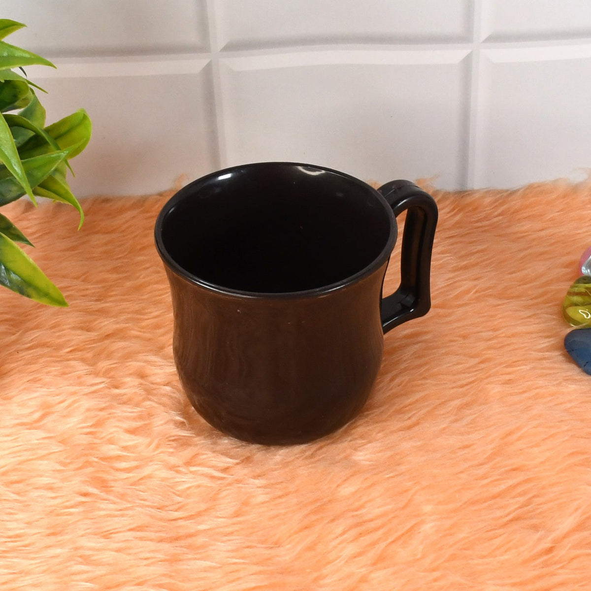 Side view of a lightweight black plastic coffee mug, emphasizing its sleek design.