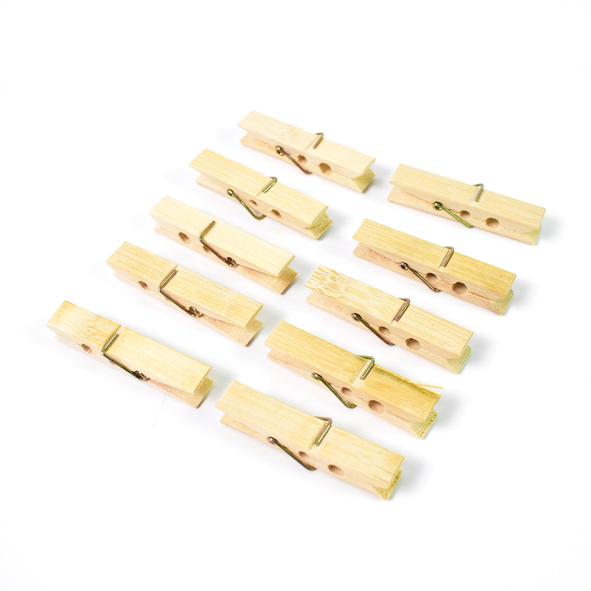 Ten light brown bamboo clothes pegs with metal springs arranged in three rows on a white background.