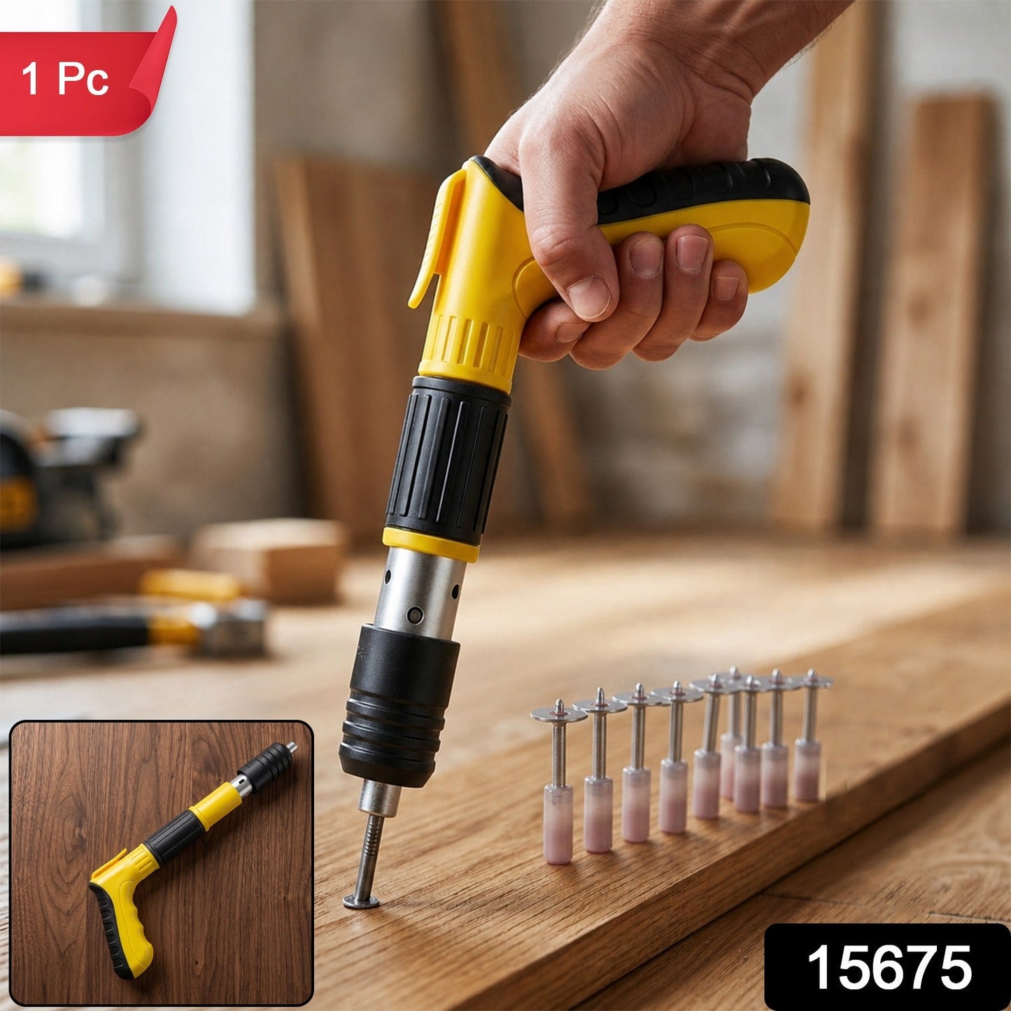 A hand holds a yellow and black manual nail gun, driving a nail into a wooden plank, with a small inset of the tool and a