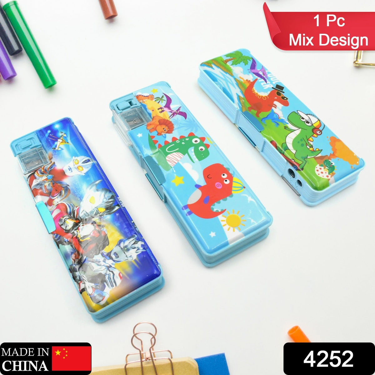 Three pencil cases, two blue with dinosaurs and one blue with Ultraman characters, on a white surface.