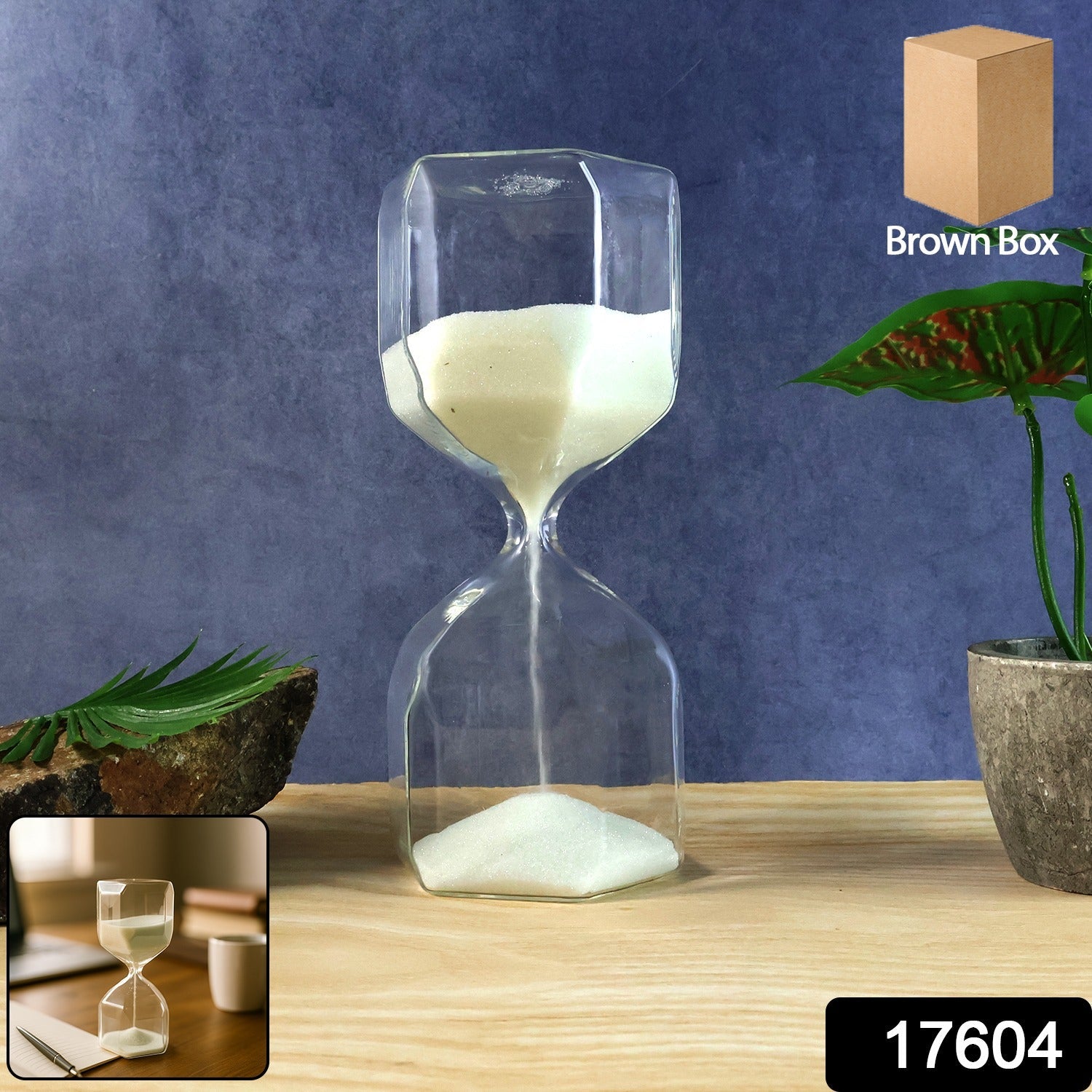 Minimalist glass hourglass sand timer placed on a wooden surface for focus and mindfulness