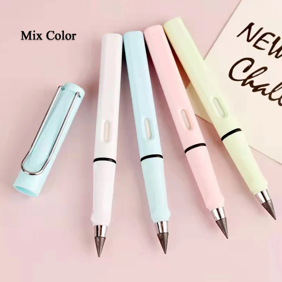 Four pastel-colored inkless pencils, one with its cap off, are arranged on a pink surface.