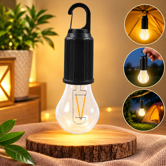 A clear LED bulb with a black top and carabiner hook sits on a wooden pedestal, glowing warmly.