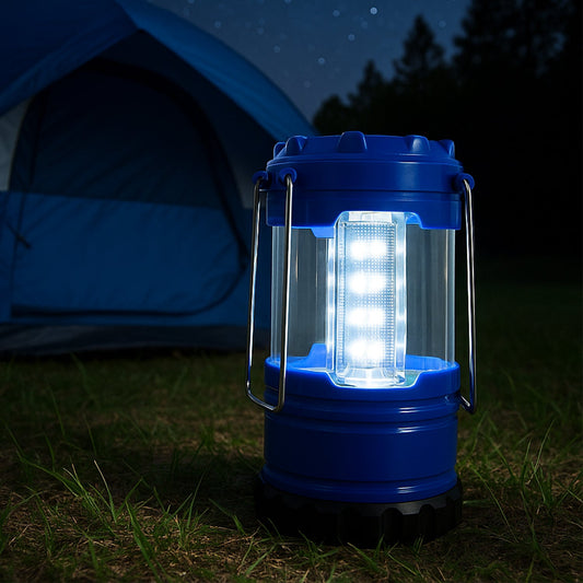 A blue lantern with 12 bright white LEDs illuminates the grass in front of a blue tent at night.