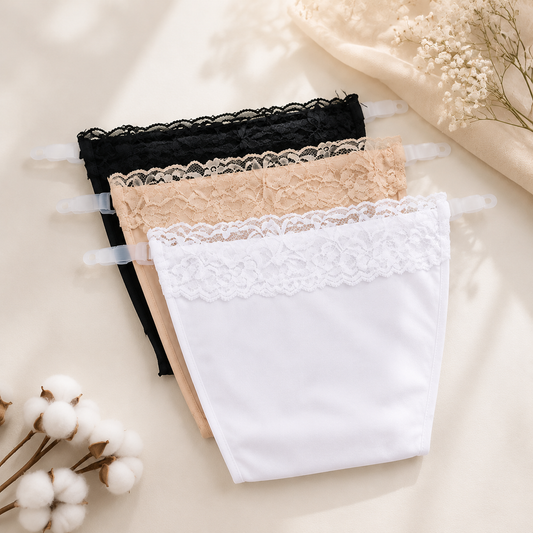 Three clip-on modesty camisoles in black, beige, and white with lace trim, on a light background with cotton bolls.