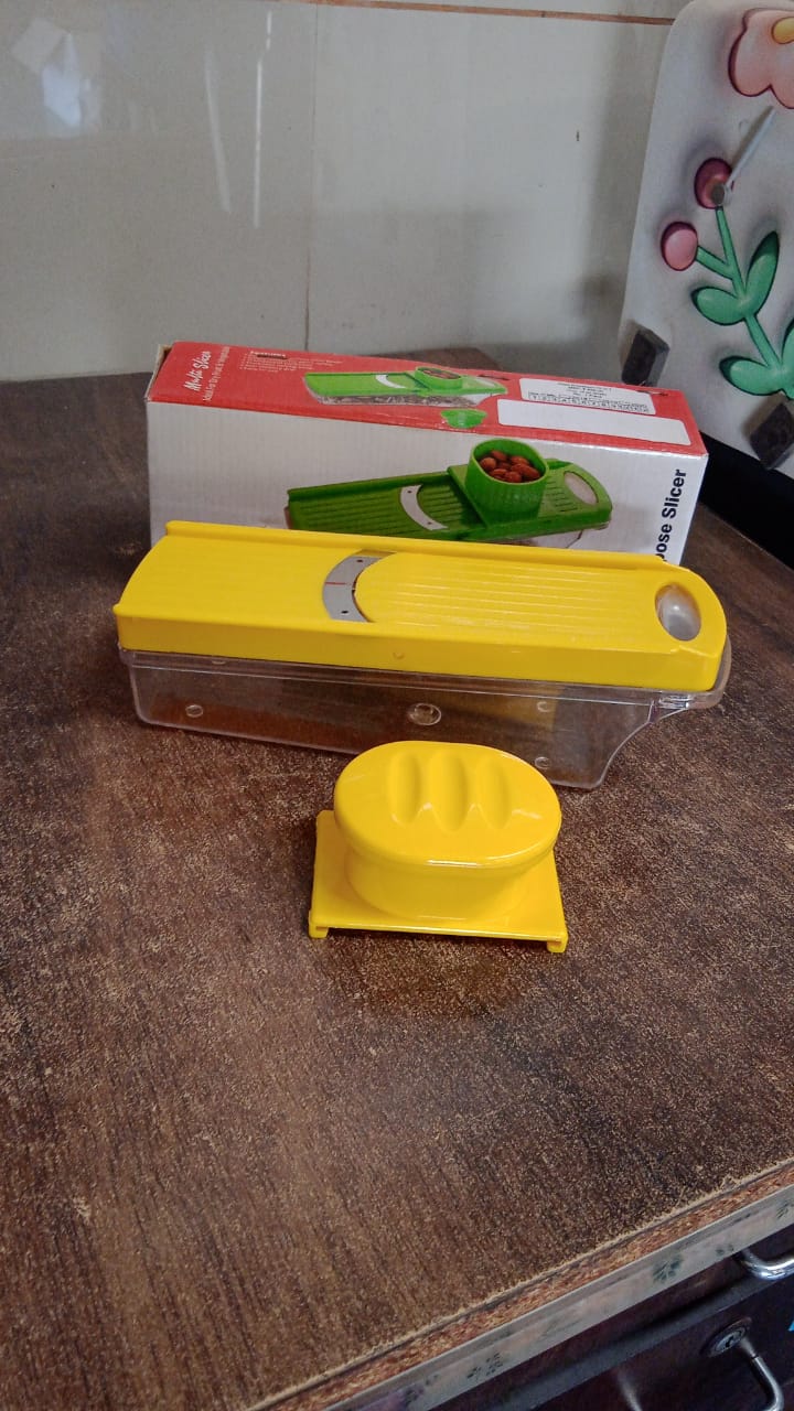 Close-up of vegetable slicer blade and yellow ABS plastic handle