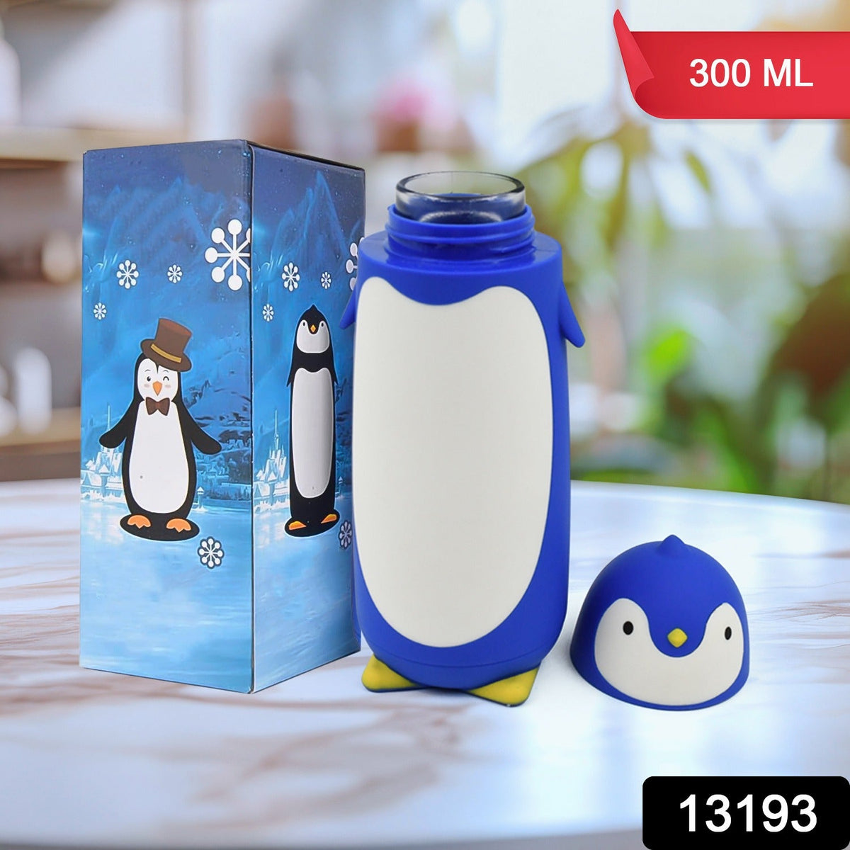 Blue penguin water bottle with yellow feet, next to a blue box with a penguin illustration, with a red 300 ML tag.