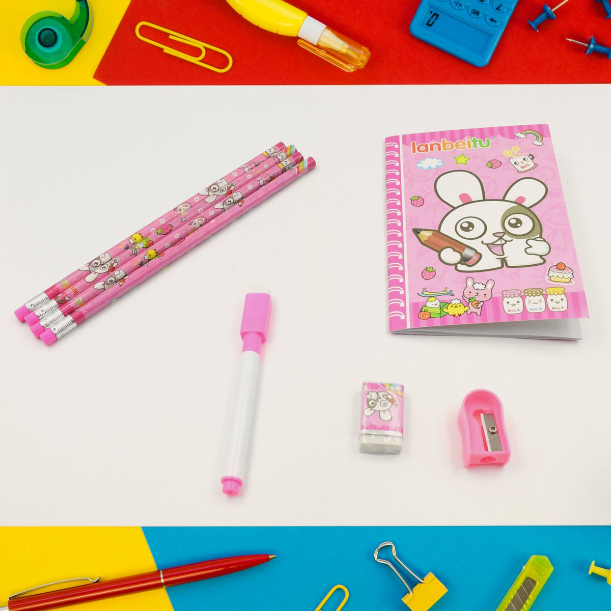 Pink bunny pencils, a marker, an eraser, and a sharpener are on a white surface with colorful office supplies around them.