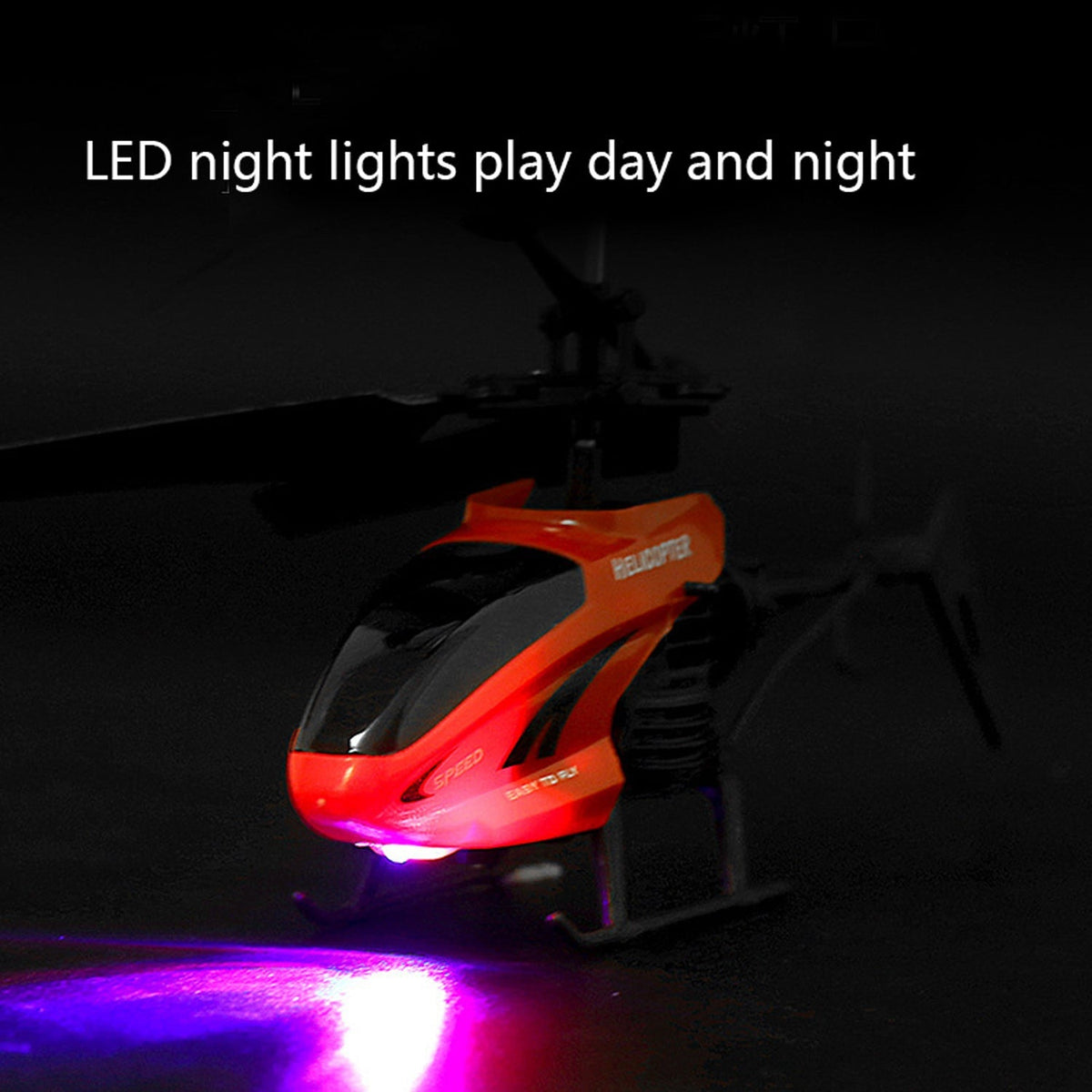 A red and black toy helicopter with glowing LED lights, casting a purple light on the dark surface below.