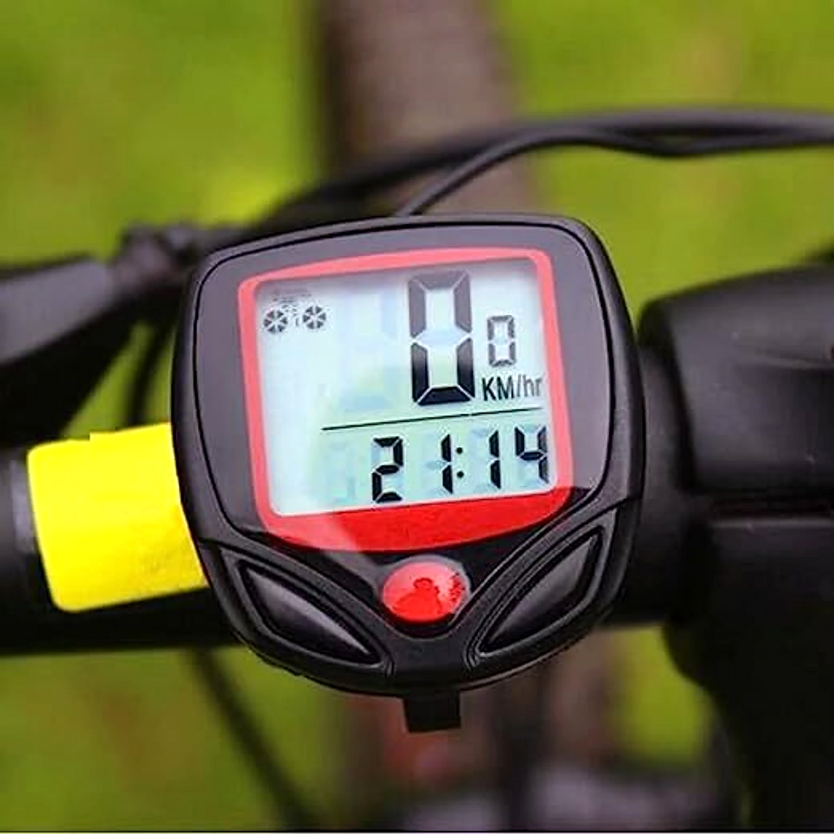 Close-up of a black and red bicycle computer displaying 0 KM/hr and 21:14 on a bike handlebar.