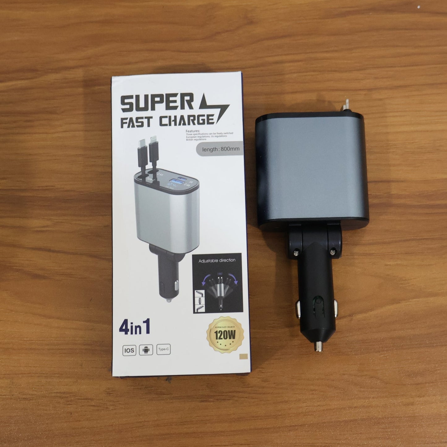 The 4-in-1 car charger in its retail box, next to the charger itself, on a wooden surface.