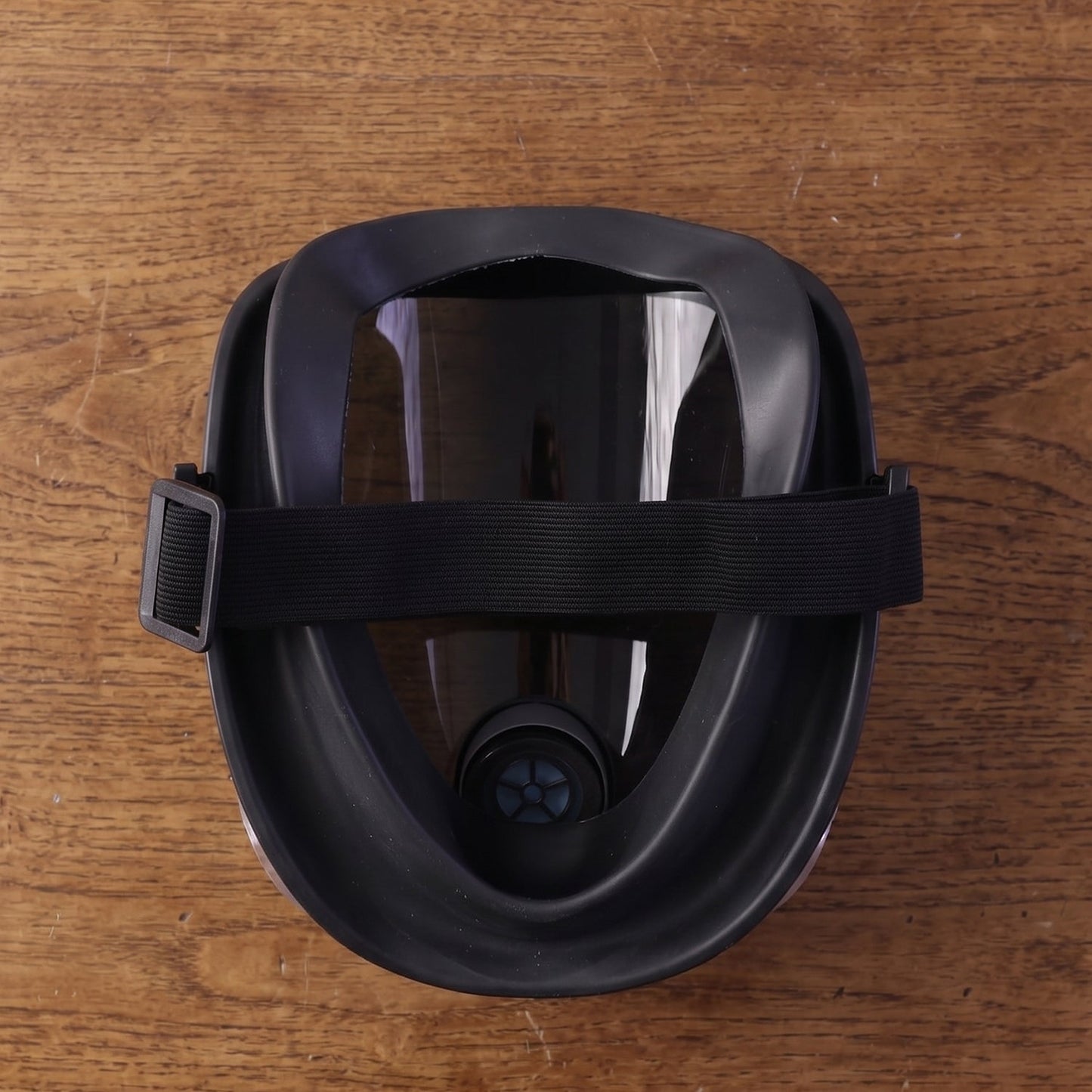 Back view of the black full face respirator mask, showing the adjustable black elastic headband and inner seal.