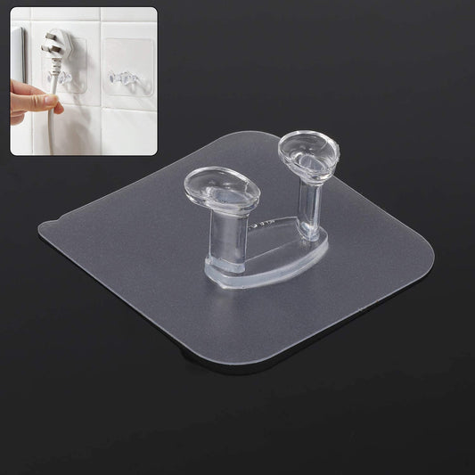 Transparent self-adhesive wall hook mounted on a clean, smooth wall.