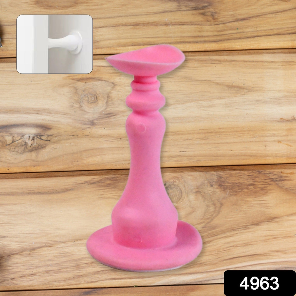 Pink silicone door stopper standing upright on a wooden surface, with a small inset of a white door stop.