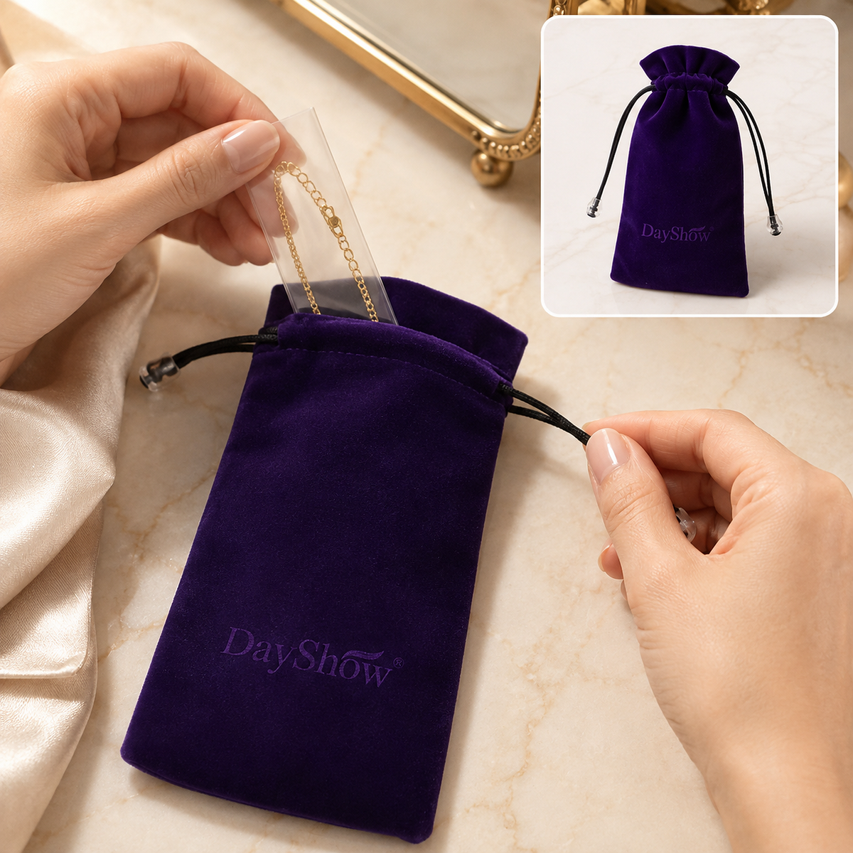 Hands placing a gold chain into an open purple velvet drawstring bag with a DayShow logo, with a closed bag in the upper