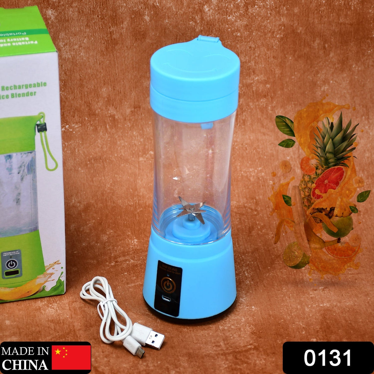 A blue portable juicer blender and its white USB charging cable are on a brown surface next to its green and white box.