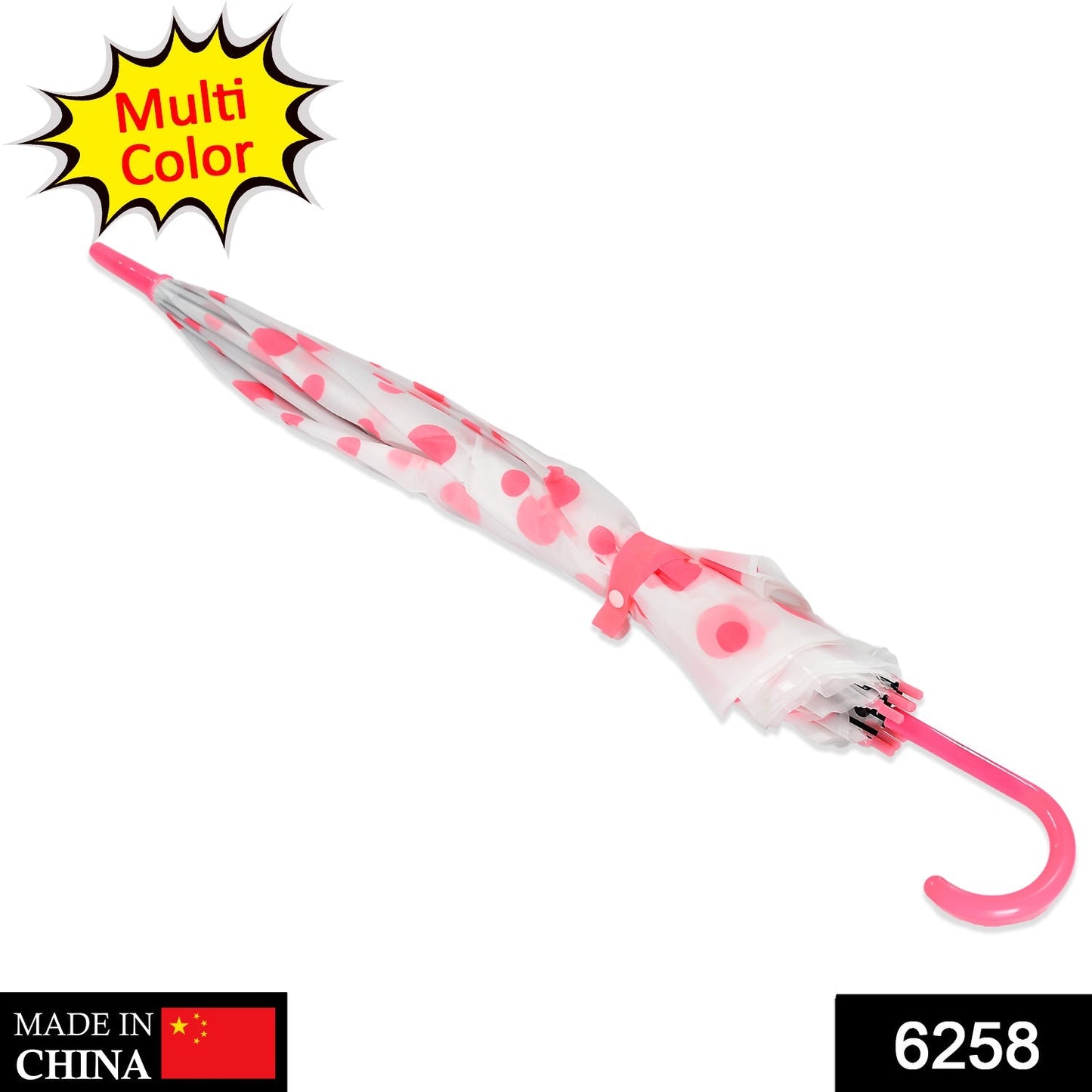 A closed white umbrella with pink polka dots and a hooked pink handle lies diagonally on a white surface.