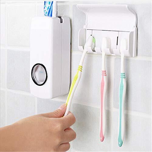 A hand holds a yellow toothbrush to the dispenser, with two other toothbrushes hanging in the holder.