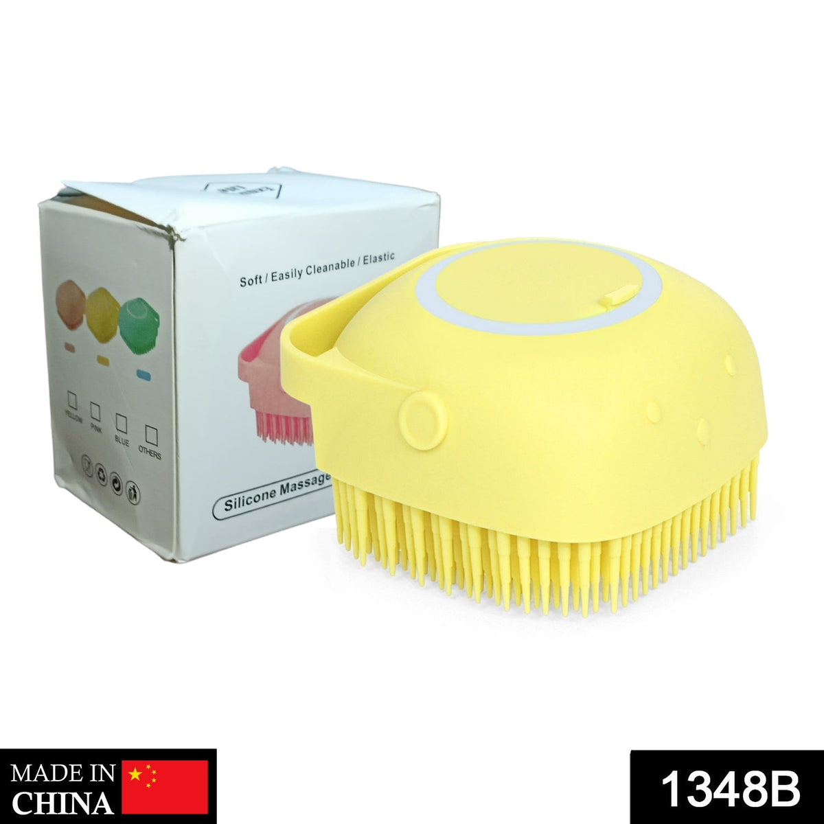 A yellow silicone massage brush sits next to its white and blue product box with text on a white background.