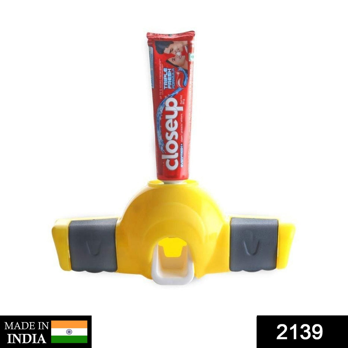 Yellow and gray toothpaste dispenser with a red tube of toothpaste on a white background, with 'MADE IN INDIA' and '2139'