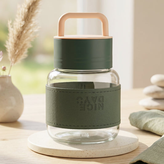 Glass water bottle with handle and leather sleeve in stylish green color