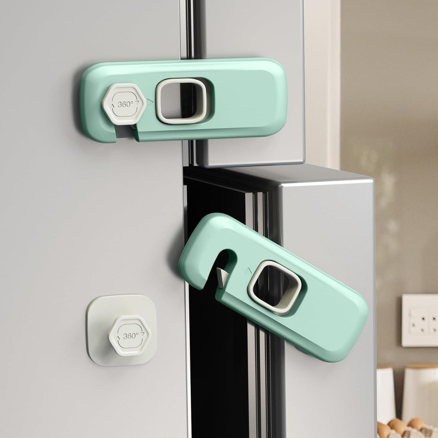 Two green and white child safety locks securing a refrigerator door, with an inset showing the lock components.