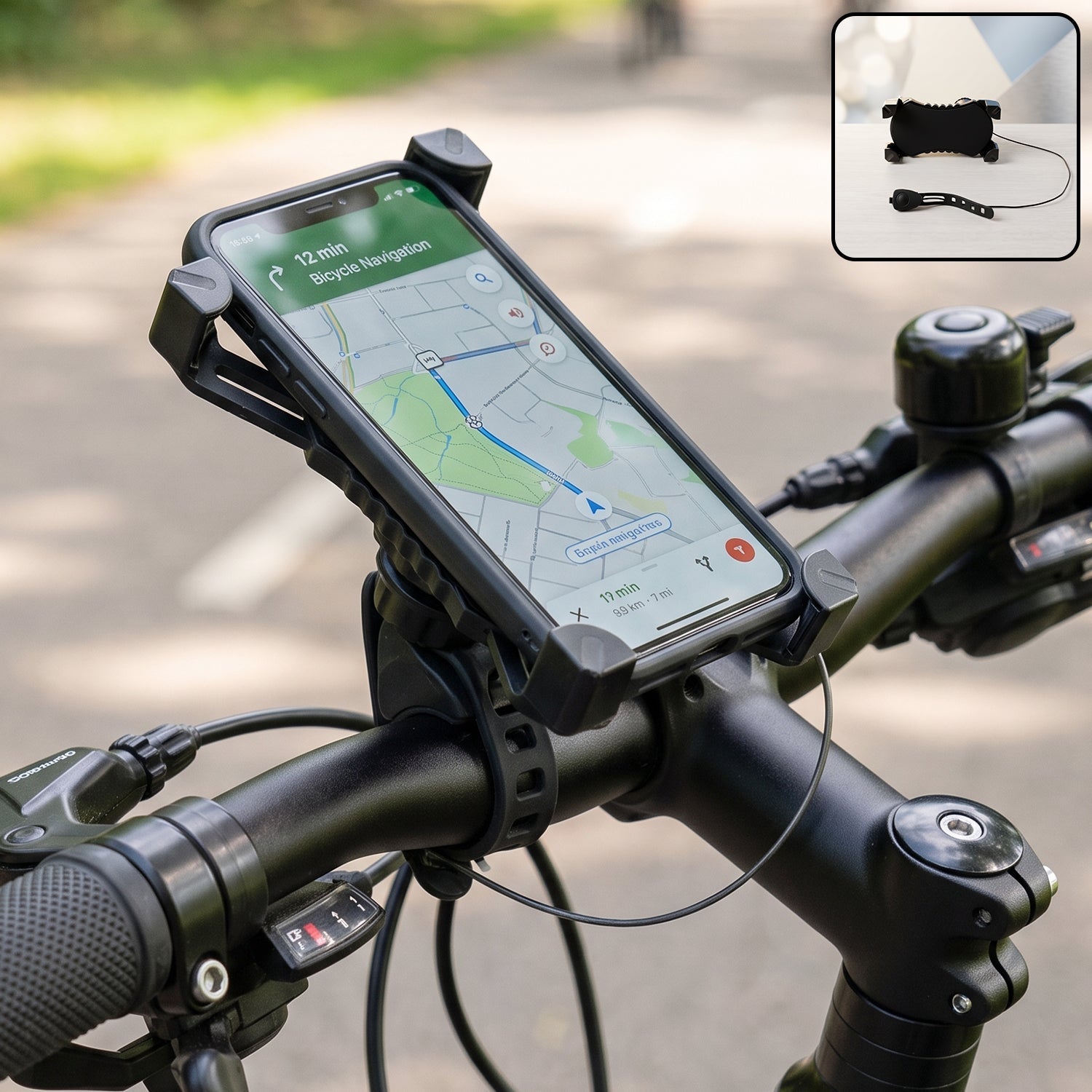 A black phone holder with a phone displaying a map is mounted on bicycle handlebars, with a small horn shown in the corner