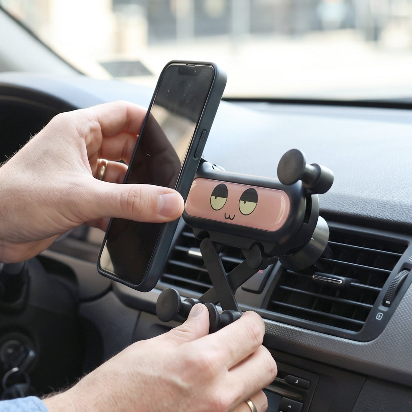 Car phone holder clipped onto an air vent