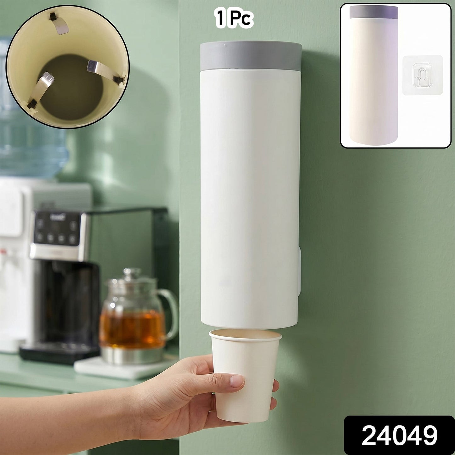 A white wall-mounted cup dispenser with a gray lid, dispensing a white paper cup into a hand, with an inset showing cup