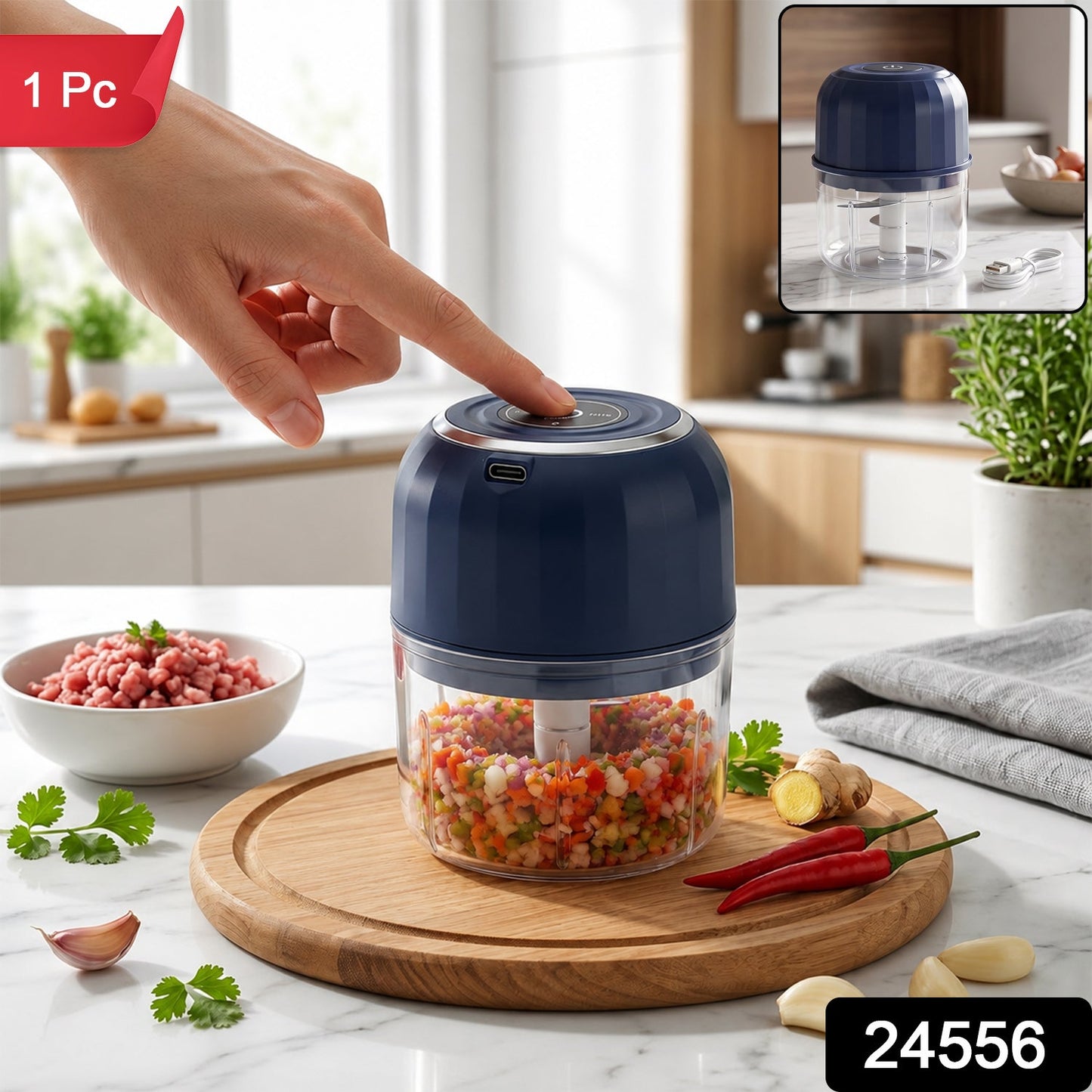A hand presses the button on a dark blue mini food chopper with a clear glass bowl full of finely chopped vegetables (1 Pc).