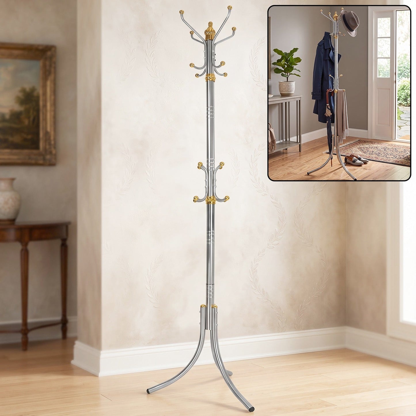 A tall, silver-colored metal clothes hanger stand with gold accents and multiple hooks stands in a room with a painting and