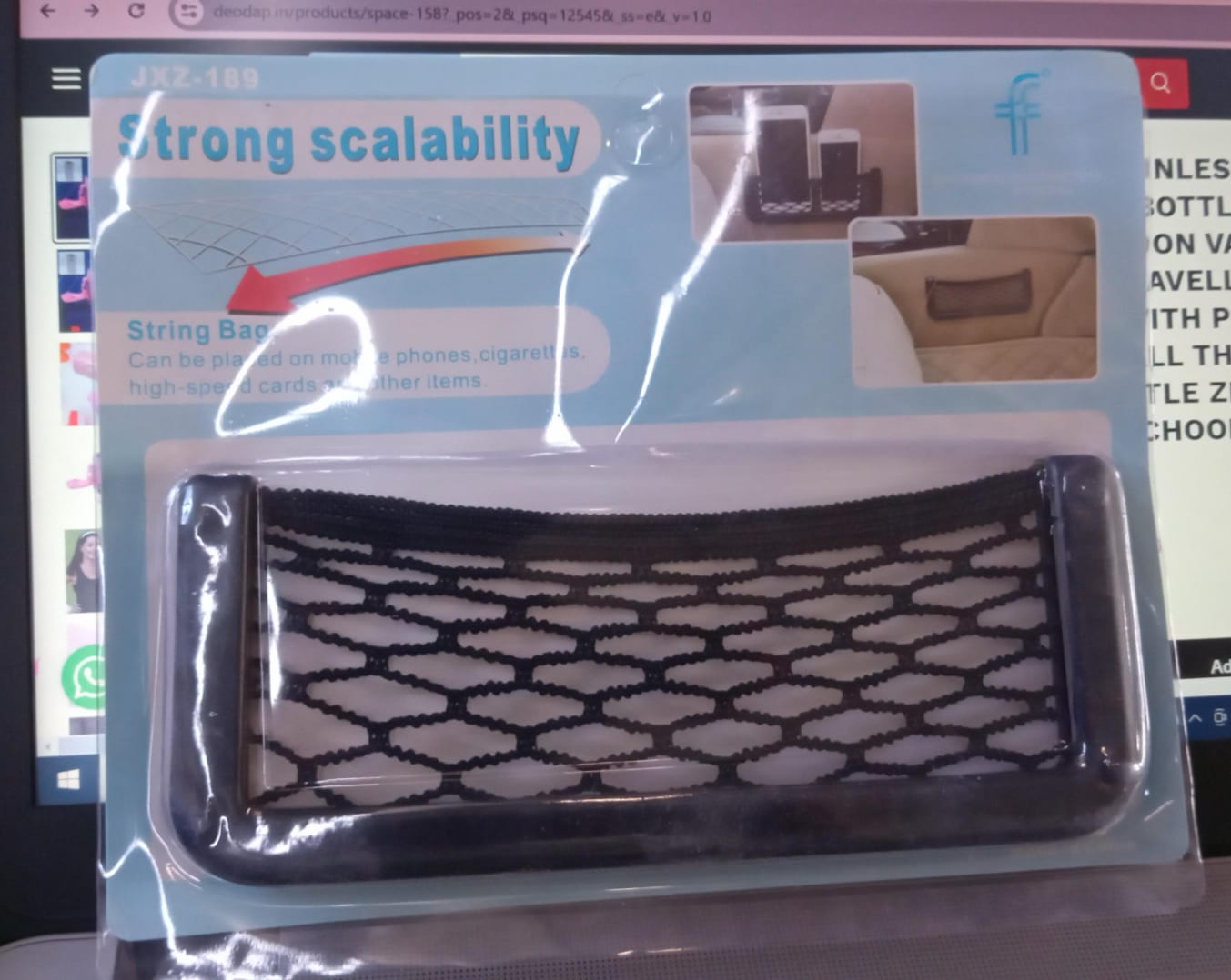 A black mesh car organizer in clear plastic packaging with