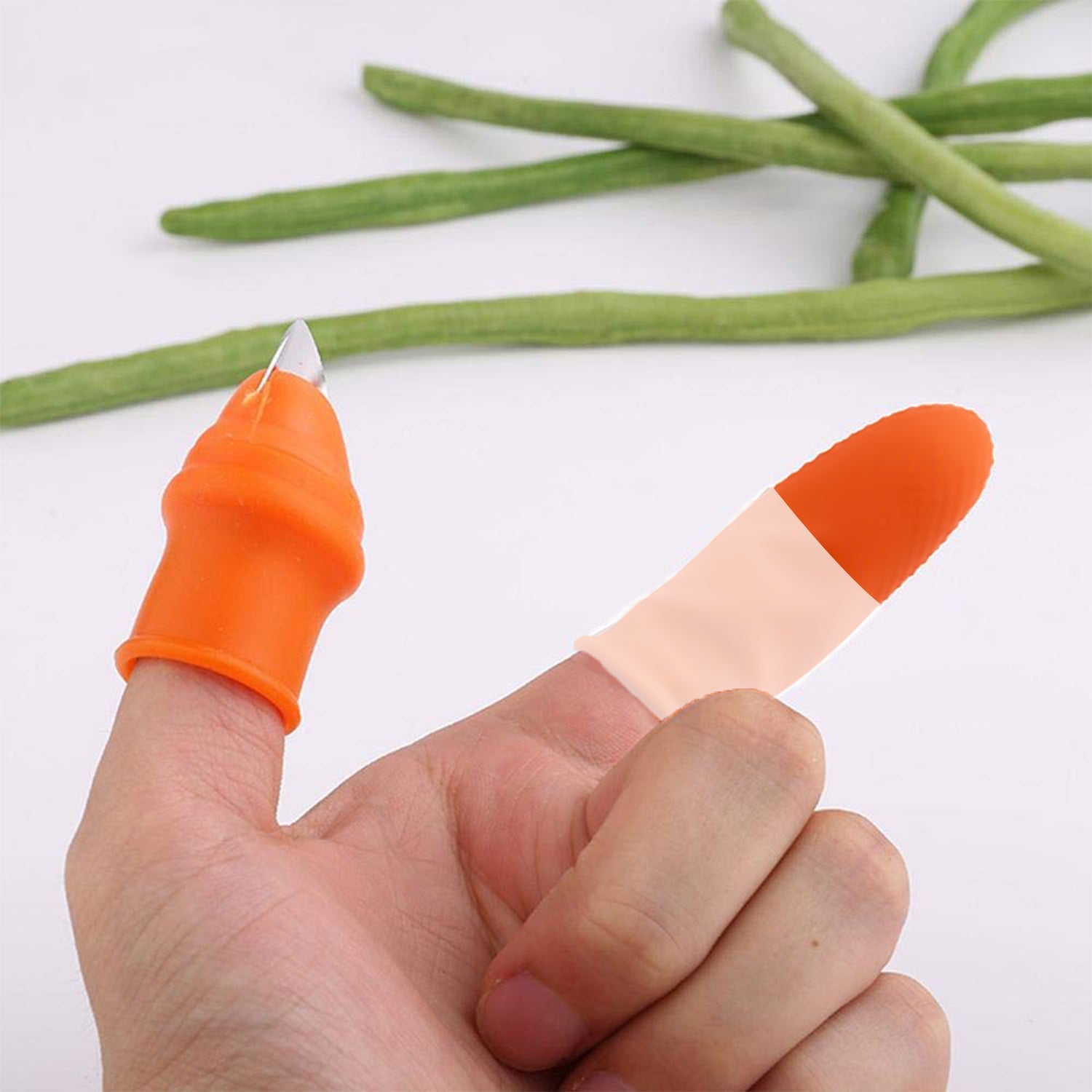 A hand wearing an orange thumb cutter and a beige finger protector, with green beans in the background.