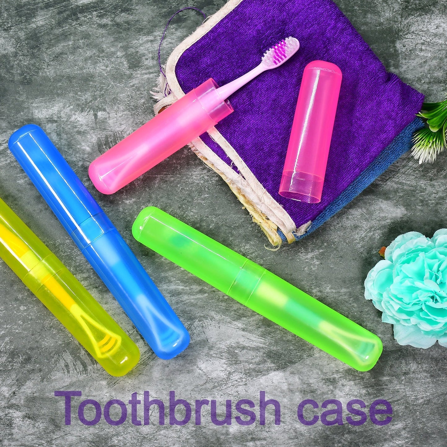 Three colorful toothbrush cases in yellow, blue, and green, with a pink case holding a toothbrush on a purple towel.