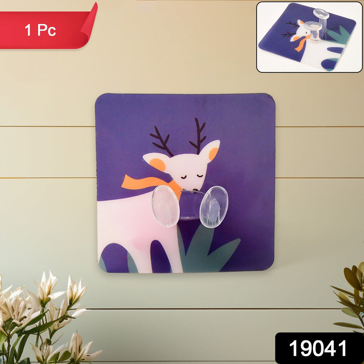 A blue square wall hook with a white deer design on a light green wooden wall, with an inset showing the hook.