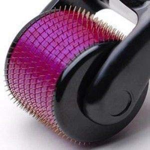 A close-up view of the purple derma roller head with numerous fine gold needles.