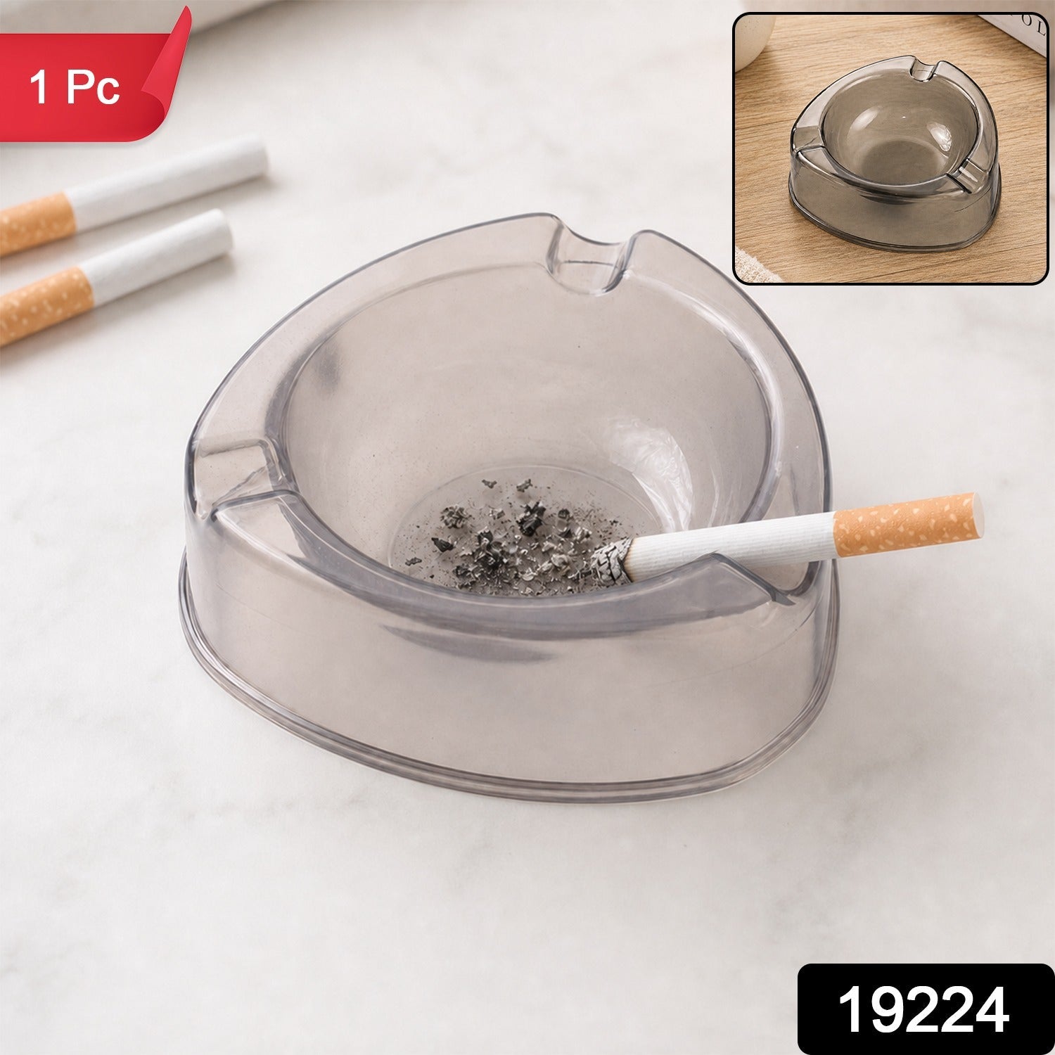 A sky blue transparent plastic ashtray is centered among cigarettes, coffee beans, sugar cubes, and a lighter.