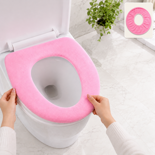 Hands adjusting a pink soft fabric toilet seat cover onto a white toilet in a bathroom.