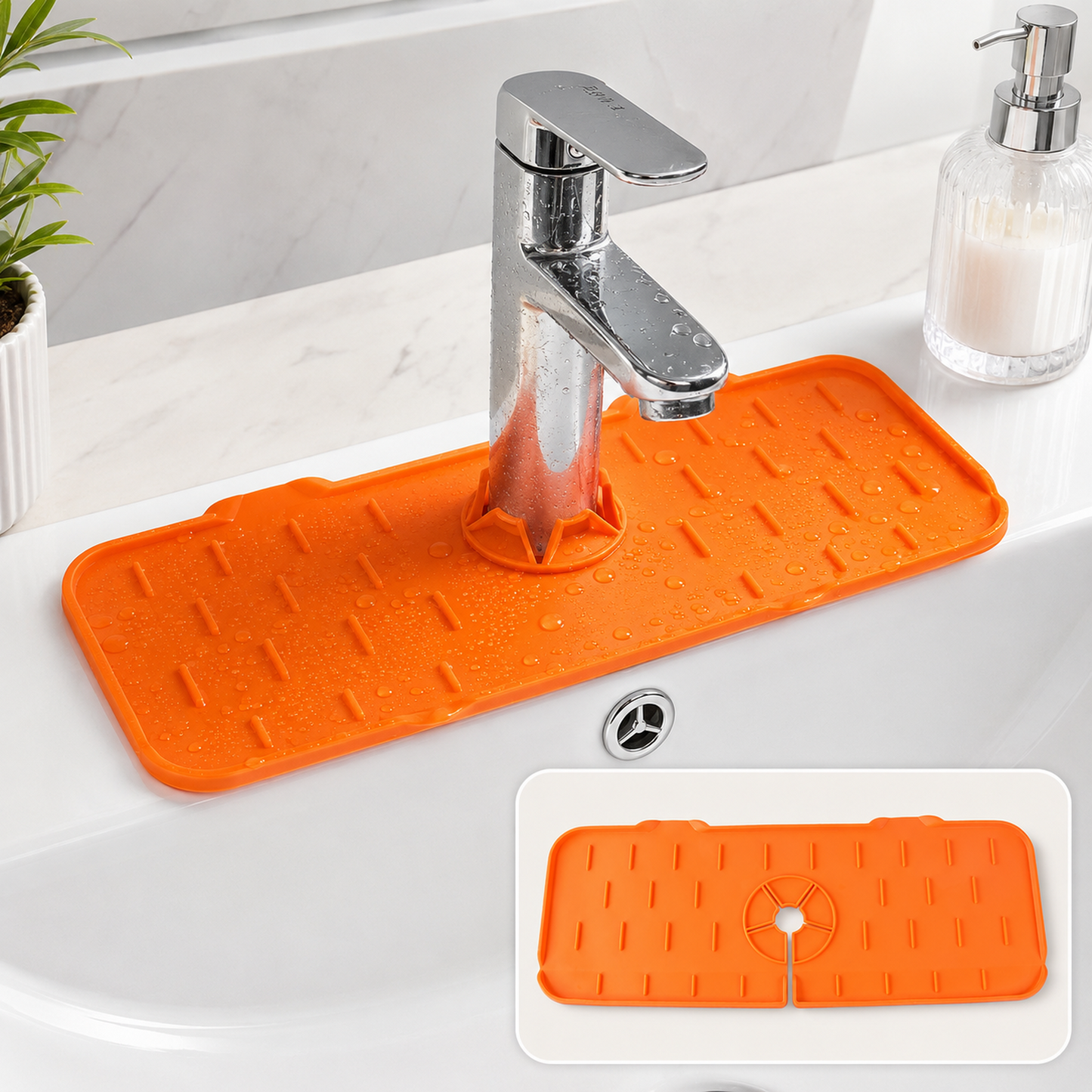 Orange silicone faucet splash guard with water droplets on a white bathroom sink with a chrome faucet.