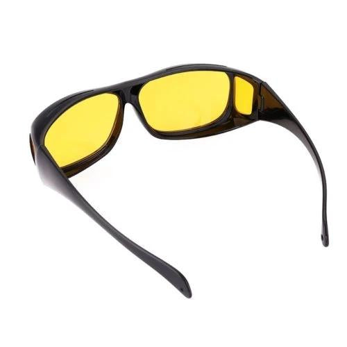 A single pair of black wrap-around glasses with yellow lenses, viewed from the top-right, on a white background.