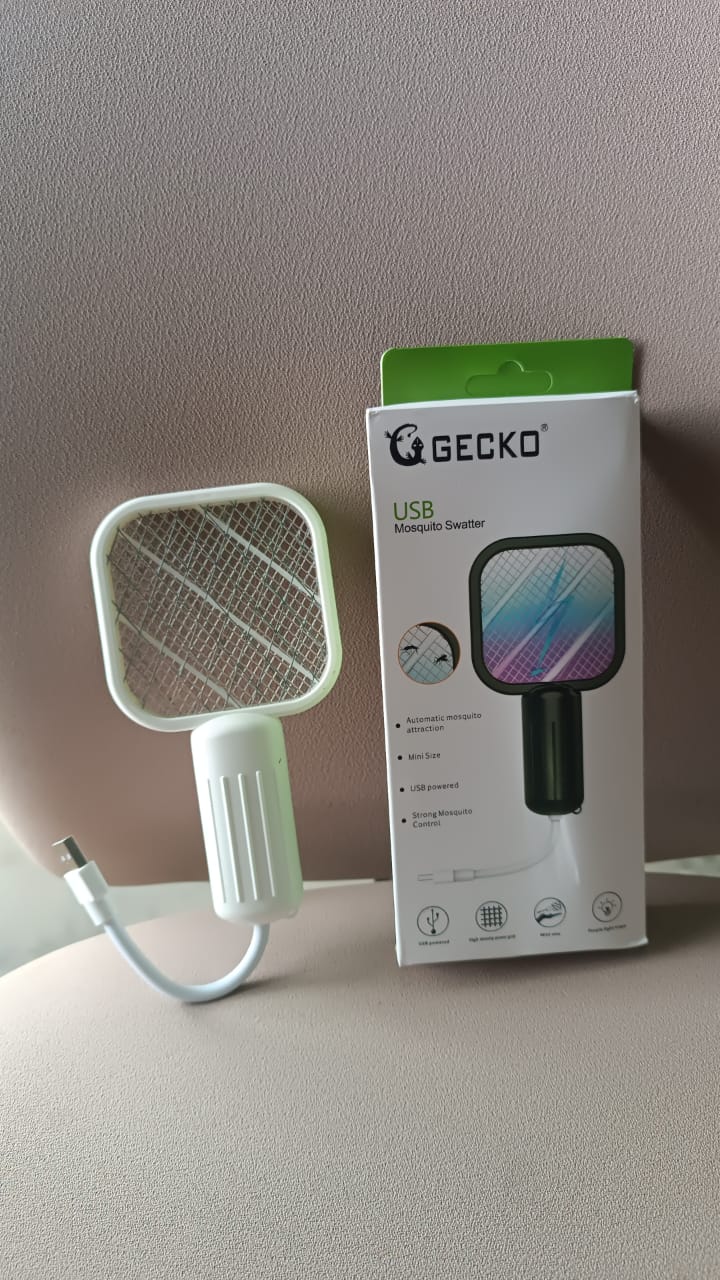 A white electric bug zapper with a square head and ribbed handle, connected to a USB cable, next to its white and green