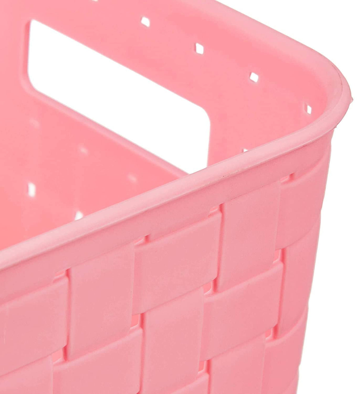 Close-up view of the top corner of a pink plastic storage basket with a woven pattern and handle.