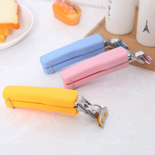Stainless steel Hot Dish Plate Clip gripping a hot bowl, showcasing its secure hold.