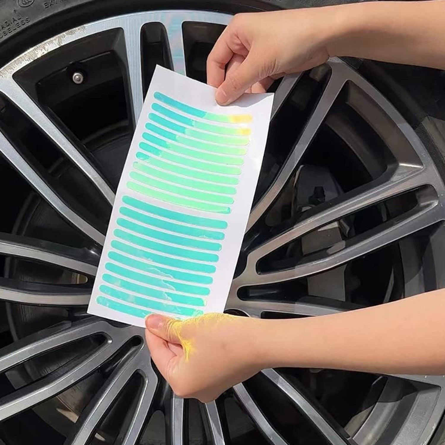 Set of colorful reflective car wheel stickers laid out, showing their reflective surface.