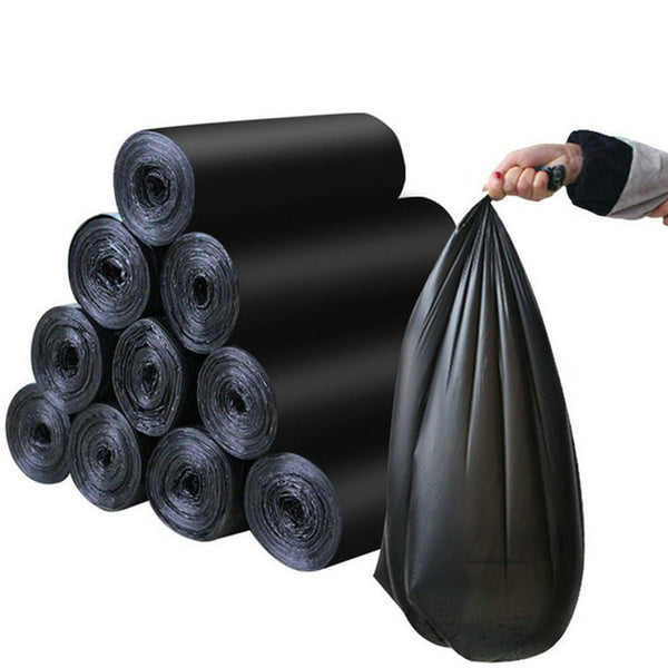 A hand holds up a single black garbage bag next to a stack of ten black garbage bag rolls.