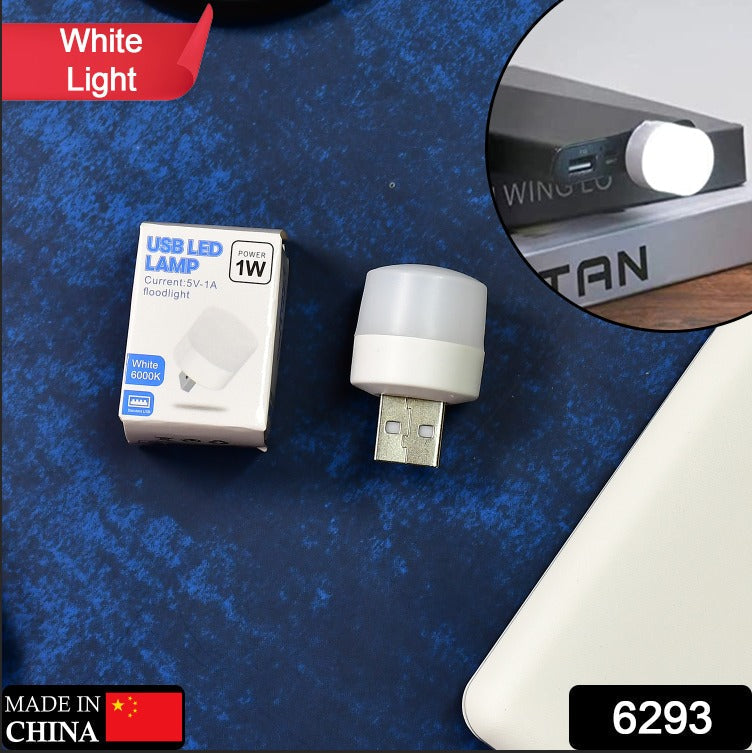 A white USB LED lamp and its small white packaging are displayed on a blue textured surface.