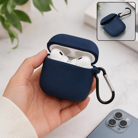 A hand holds a navy blue silicone earbud case with white earbuds inside, next to a phone.