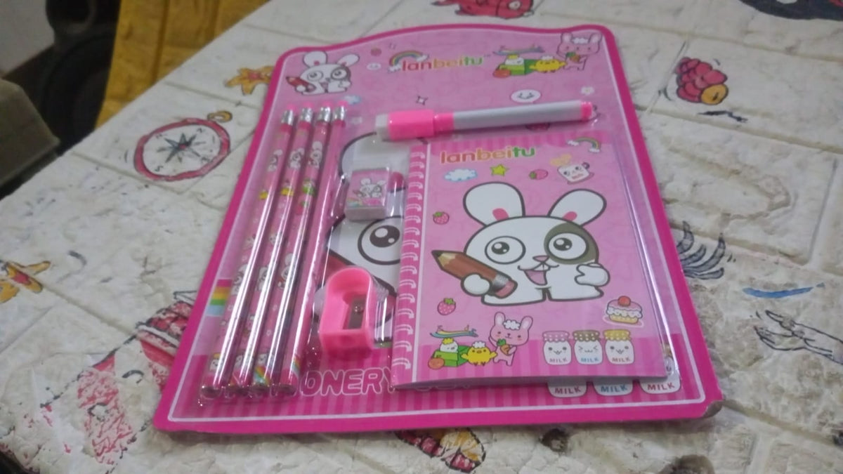 Close-up of wooden pencils, sharpener, eraser, and diary from the pink bunny themed stationery set.