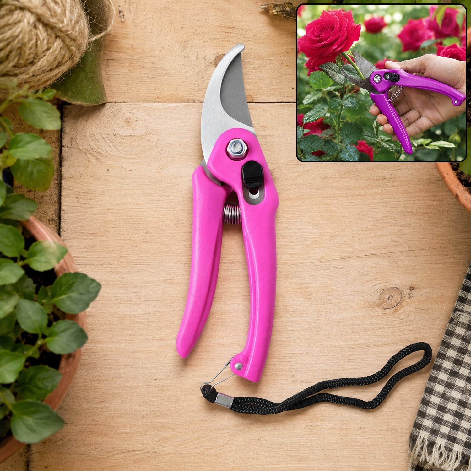 A pink garden pruner with a black wrist strap lies on a wooden surface next to potted plants and twine.